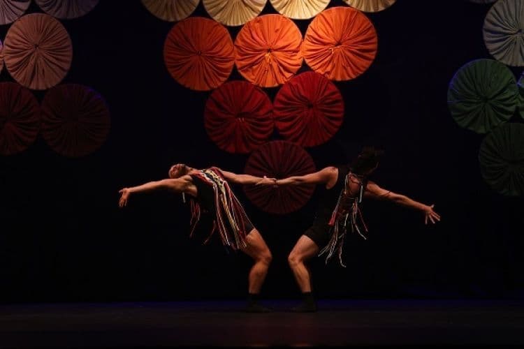 Bailarinos da FOHAT Cia de Dança em cena no espetáculo Fuxico, com figurinos coloridos e elementos do artesanato nordestino