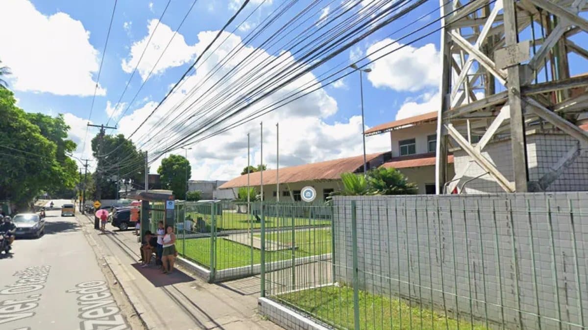 Fachada de UPA no Recife à noite com viaturas policiais