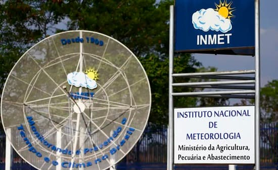 Vento forte movendo árvores em área urbana durante alerta meteorológico
