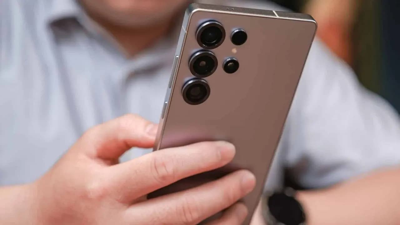 Homem segurando um Galaxy S25 Ultra, da Samsung; foto mostra a parte traseira docelular - Imagem: tinhkhuong/Shutterstock