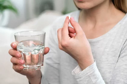 Mulher Com Um Remédio E Copo De Água / Crédito: Brizmaker (Shutterstock/Reprodução)